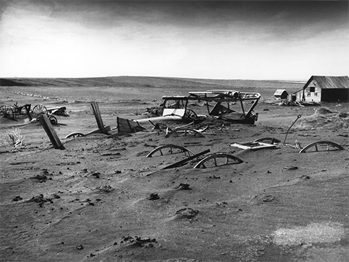 dust covering cars and fences in the dust bowl of the 1930s